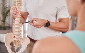 A person gently stretching their back in a bright living room with visible furniture and soft sunlight.
